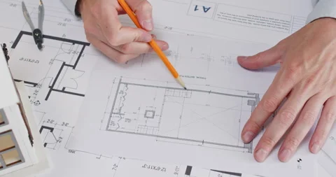 Experienced man architect examines detailed sketch of flat room Stockbeeldmateriaal 314730309