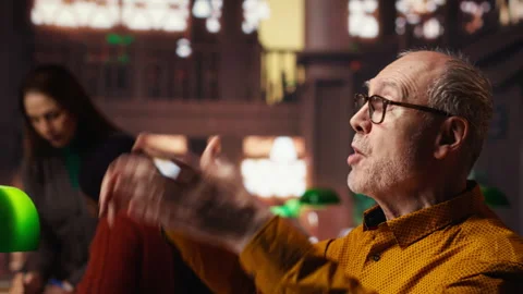 Experienced man rehearsing a theatre script in a quiet library Stock Footage 313305421