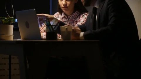 Experienced manager teaching helping new hire intern late at workplace Stock Footage 80724771