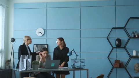 Experienced manager teaching new hire intern late in office, explaining project Stock Footage 130868033