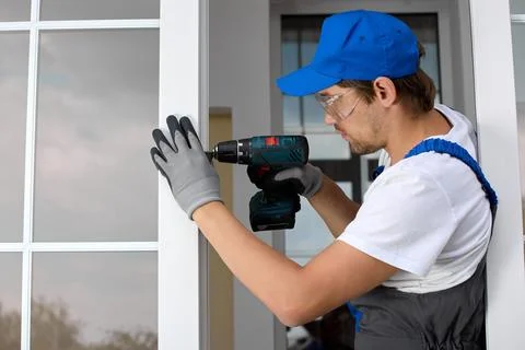 Experienced master performs glazing of the balcony of the living room Stock Photos