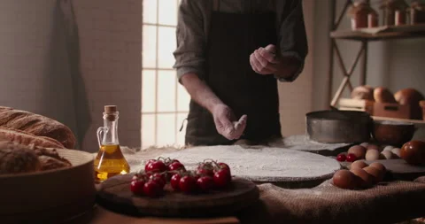 Experienced mature chef applying flour on hands before making traditional bread Stock Footage 133124162