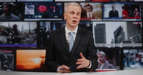 Experienced News Presenter Analyzing Urgent World Events Against Video Wall of Stock Footage 332568206