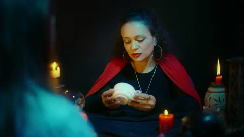 Experienced oracle reading coffee grounds and interpreting patterns to client Stock Footage 197990318
