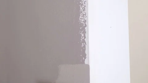 Experienced painter with roller brush colours room wall Stock Footage 124003457