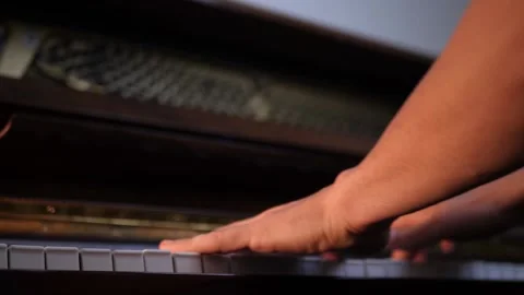 Experienced pianist playing complex melody, fingers gracefully moving across Video stock 343847395