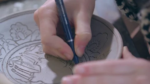 Experienced potter creating a beautiful clay souvenirs using professional tools 스톡 동영상 83647327