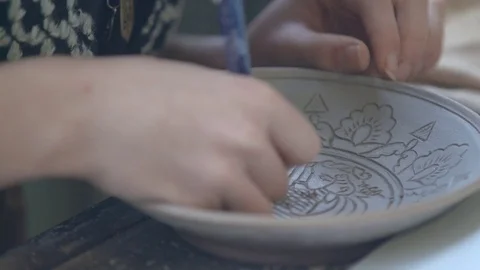 Experienced potter creating a beautiful clay souvenirs using professional tools Stock Footage 83648322
