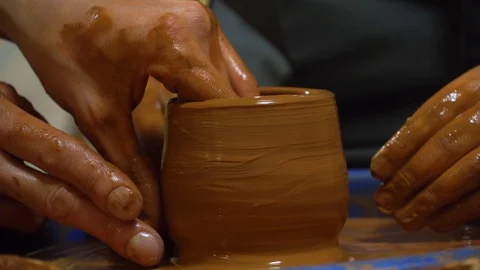 Experienced potter creating a beautiful clay pot using old tools Traditional tec Stock Footage 99773142