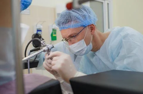 An experienced proctologist examines the patient using special devices for .. Stock Photos
