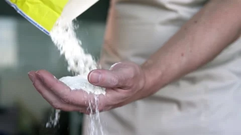 Experienced professional baker pouring flour into hands. Stock-Footage 296805505