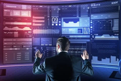 Experienced programmer looking at the screen while working with a new device Stock Photos