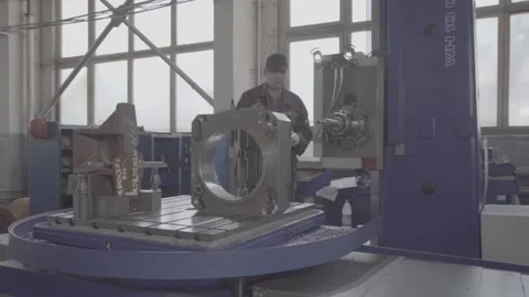 Experienced qualified worker works on precision coordinate boring machine CNC Stock Footage 105164581