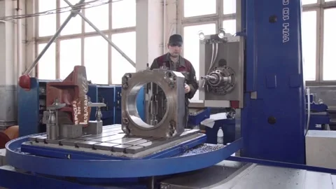 Experienced qualified worker works on precision coordinate boring machine CNC Stock Footage 105164818