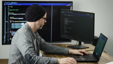 Experienced senior programmer working on a complex project. A developer writes Stock Footage 180026014