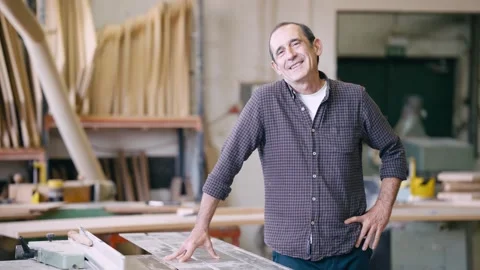 Experienced smiling carpenter working in his workshop Stock Footage 337882316