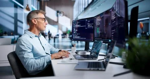 Experienced Software Developer Carefully Writing Secure Code Using Cloud-base Stock Photos