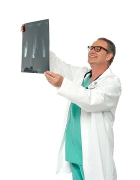 Experienced surgeon looking at x-ray report Stock Photos
