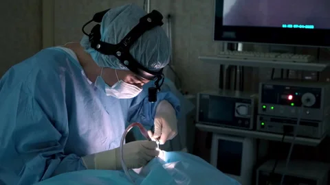 Experienced surgeon performing microsurgery under monitor supervision Stock Footage 306168036