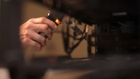Experienced technician using air duster to clean computer case for improved Stock-Footage 289904481