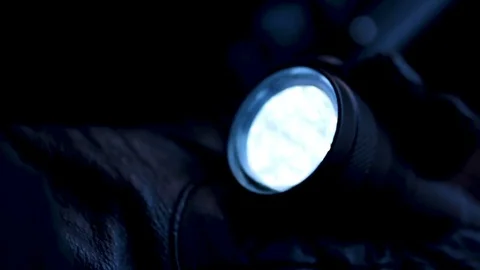 Experienced thief lighting flashlight preparing to crack lock and commit robbery Stock Footage 80963069