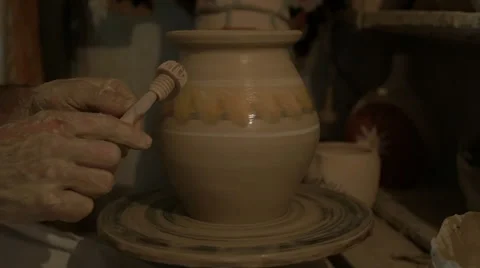Experienced traditional dressed potter creating a beautiful clay vase Stock Footage 63524065