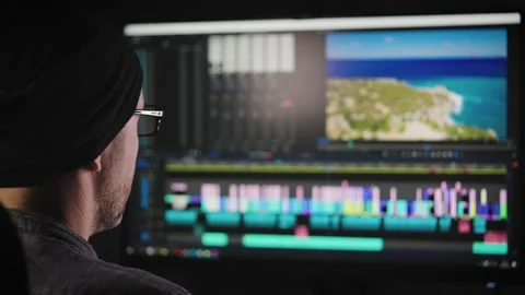 Experienced video editor working on a big project. A man edits a blog or a movie Stock-Footage 174297708