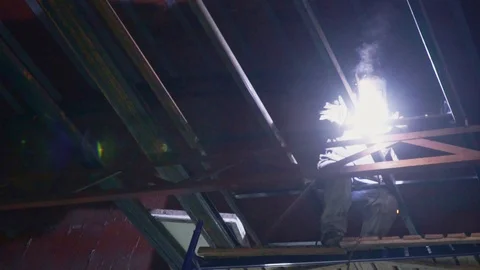 An experienced welder welds a construction in slow motion Stock Footage 104222230