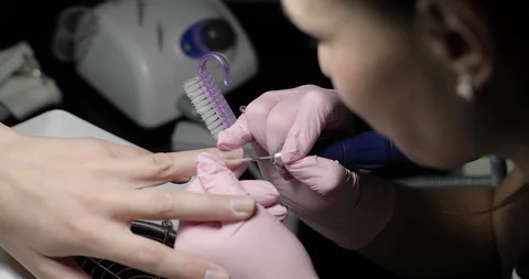 An experienced woman gently makes hardware manicure girl. Stock Footage 103671040