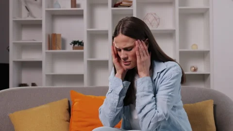 Experiencing headache, stressful couch, reading tension Stock Footage 300126988