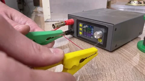 An experiment with a burnout wire. The master demonstrates the power of elect Stock Footage 130779804