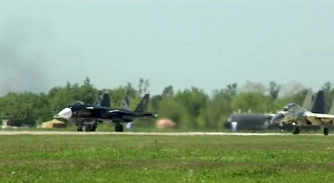 Experimental Su-47 Berkut, Su-30SM and Su-35 are moving along runway Stock Footage 196707835