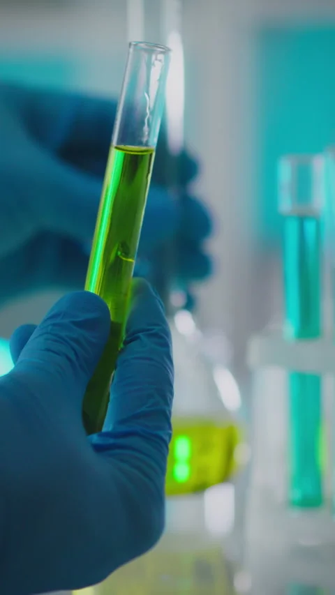 Experimenter conducts chemical analysis using test tubes in a laboratory set Stock Footage 331574007