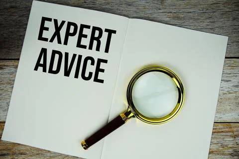 Expert Advice text message written on paper note with magnifying glass top .. Stock Photos