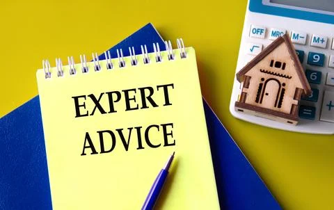 EXPERT ADVICE - words in a yellow notepad with a calculator and a wooden ho.. Stock Photos
