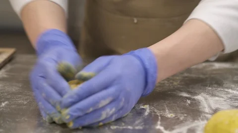 An expert baker rounding and shaping dough into classic bread loafs and placing Stock Footage 106255369