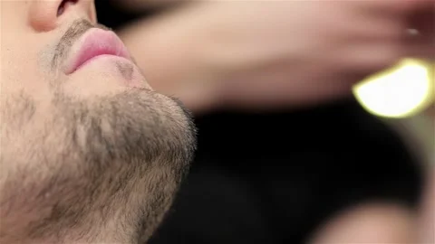Expert barber meticulously styling a beard in a trendy men's salon Stock Footage 311826618