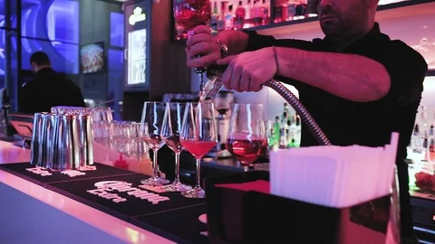 Expert barman is making cocktail at night club. Stock Footage