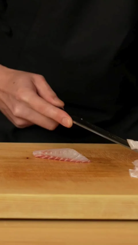 Expert chef slices white fish fillet into thin strips Video stock 331770419