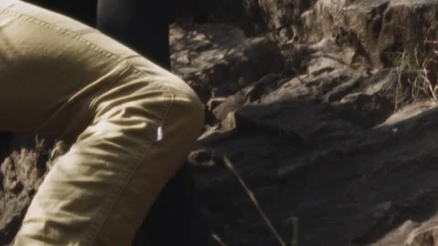 Expert Climber Engages with Challenging Rock Face: A Portrait of Focus and Stock Footage 275855052