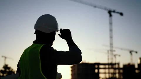 Expert on construction site, man viewing building process, cinematic shot. Back Stock Footage 317806604