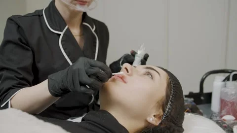 Expert cosmetology session featuring permanent makeup application Video stock 314257380