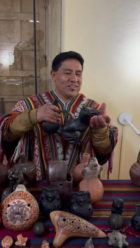 Expert Demonstrates Peruvian Whistling Jar and Other Andean Instruments, Cusco,  Stock Footage 346645430