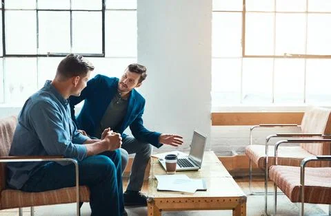 Expert developers doing what they do best. two young businessmen having a 스톡 사진