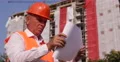 Expert Engineer Checking Blueprint Paper Plans Under Construction Area Buildings 4k or 4k+ Resolution