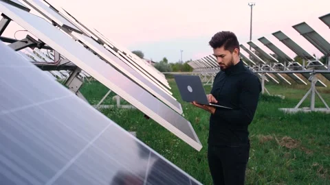 An expert engineer in uniforms examines the construction plan . Stock Footage 140209347