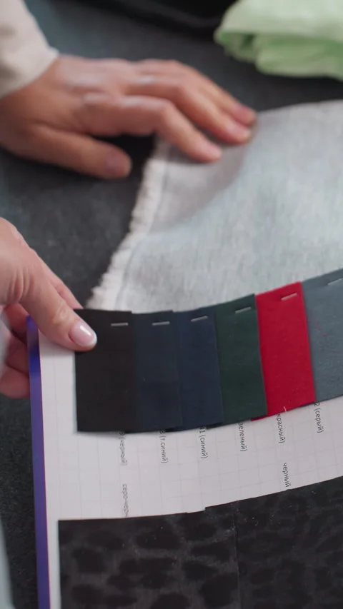 Expert examining fabric textures under bright lighting, Thorough evaluation of Stock Footage 323803277