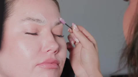 The expert eyebrow styling process utilizes the precise application of brow gel Video stock 336470907