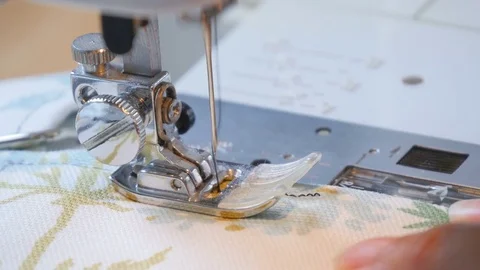 Expert female hands using sewing machine stitching fabic togeather to make arts Stock Footage 77117925