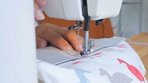 Expert female hands using sewing machine stitching fabic togeather to make arts Stock Footage 77130000